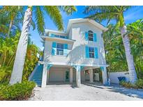 Two-story home with light blue accents at 508 Spring Ave, Anna Maria, FL 34216