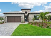 Stunning curb appeal with a stone facade at 524 Bocelli Dr, North Venice, FL 34275