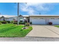 Front view of charming villa with double garage at 5372 Pamela Wood Way # 7, Sarasota, FL 34233