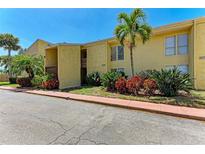 Building exterior showcasing yellow siding and palm trees at 3411 Clark Rd # 212, Sarasota, FL 34231