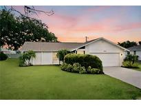 Charming single-story home with a well-maintained lawn at 9390 Gulfstream Blvd, Englewood, FL 34224