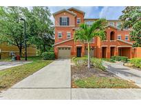 Two-story townhome with attached garage and landscaped front yard at 7344 Black Walnut Way # 4601, Lakewood Ranch, FL 34202