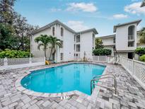 Beautiful in-ground swimming pool with palm trees and lounge chairs at this condo complex at 6304 Pointe West Blvd # A102, Bradenton, FL 34209