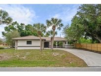 Single Gathering home with palm trees and large driveway at 2316 Achilles St, Punta Gorda, FL 33980