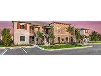 Tan colored, multi-unit residential building with parking at 23853 Collina Way # 6104, Port Charlotte, FL 33980