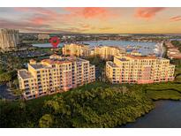 Stunning aerial view of the multi-Gathering dwelling and marina, set against a vibrant sky at 611 Riviera Dunes Way # 108, Palmetto, FL 34221