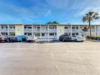 Two-story condo building with parking and tropical landscaping at 1521 Pleasant Rd # A24, Bradenton, FL 34207