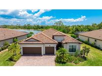 This charming house boasts a tile roof and a two car garage at 13715 Vancanza Dr, Venice, FL 34293