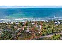 Oceanfront property with expansive beach views and lush landscaping at 7730 Manasota Key Rd, Englewood, FL 34223