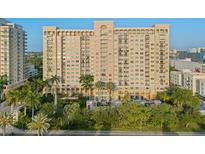 High rise building with balconies and lush landscaping at 750 N Tamiami Trl # 1115, Sarasota, FL 34236