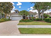 Charming single-story home with lush landscaping and a brick-paved driveway at 7249 Orchid Island Pl, Bradenton, FL 34202