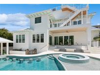 Inviting swimming pool featuring a swim up bar and spa, surrounded by the home's outdoor living and entertaining area at 149 Mckinley Dr, Sarasota, FL 34236