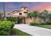 Two-story house with tile roof, double garage, and landscaped front yard at 7738 Calle Facil, Sarasota, FL 34238