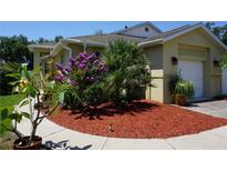 Tan house with landscaped yard, walkway, and two-car garage at 203 28Th W St, Palmetto, FL 34221