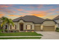 Inviting single-story home featuring a well-manicured lawn and an attached two-car garage at 6309 75Th E Ave, Palmetto, FL 34221