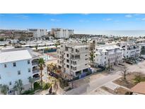 Aerial view of a new construction development, featuring multiple buildings and a tennis court at 1150 Windsong Ln # 300, Sarasota, FL 34242