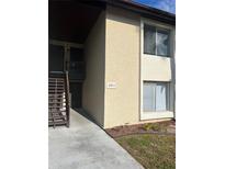 Condo building exterior with stairs and address number at 2611 Pine Lake Ter # B, Sarasota, FL 34237