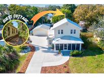 Charming home with guest cottage, featuring a metal roof and well-maintained landscaping at 1810 28Th W St, Bradenton, FL 34205