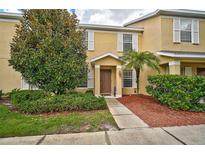 Two-story townhome with attractive landscaping and a walkway at 14939 Amberjack Ter # 102, Lakewood Ranch, FL 34202