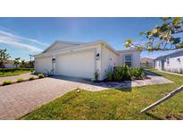 Two-car garage and front yard with landscaping at 16132 Ivy Ridge Ct, Port Charlotte, FL 33953