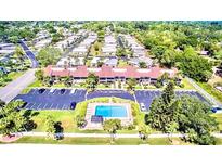 Community overview, showing homes, landscaping, and a pool at 5408 Swift Rd # 28, Sarasota, FL 34231