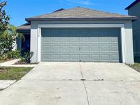 Single-story house with attached garage and landscaping at 15716 Fort Island Pl, Sun City Center, FL 33573