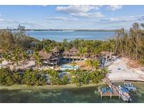 Island home with private beach, pool, and dock at 7147 La Lenaire Dr, Longboat Key, FL 34228