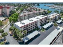 Aerial view of condo building with parking and waterfront access at 220 Santa Maria St # 240, Venice, FL 34285