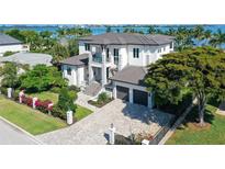 Luxury waterfront home with a large driveway and beautifully landscaped yard at 121 Seagull Ln, Sarasota, FL 34236