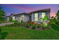 Attractive home exterior with landscaping and a two-car garage at 8705 Coastal Key Way, Parrish, FL 34219