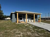 Charming single-story home featuring a modern exterior and a well-lit, covered front porch at 5310 22Nd Street E Ct, Bradenton, FL 34203