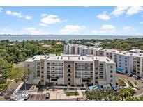 An exterior view of the condo community, with coastal views and parking at 1703 N Tamiami Trl # 302, Sarasota, FL 34234