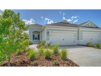Two-car garage and charming front porch at 14705 Barefoot Ln, Parrish, FL 34219