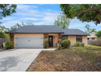 Charming single Gathering home featuring a white garage door, stone accents, and a well-maintained yard at 4175 Arrow Ln, Sarasota, FL 34232