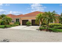 Charming home features a tile roof, two-car garage and beautiful landscaping at 5635 Spanish Point Ct, Palmetto, FL 34221