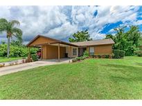 Cute two-bedroom home with carport and lush landscaping at 1705 Curry Ave # 85, Nokomis, FL 34275