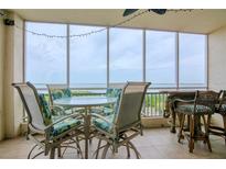 Outdoor dining set with views of the water on the screened balcony at 2825 Terra Ceia Bay Blvd # 1602, Palmetto, FL 34221