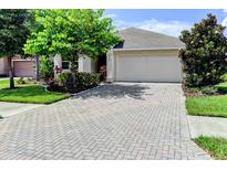 Single-Gathering home with a paved driveway and landscaping at 4247 Adelaar Dr, Sarasota, FL 34240