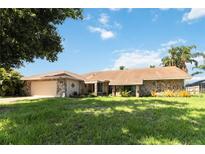 Single-story home with stone exterior and landscaped yard at 4607 Masefield Pl, Sarasota, FL 34241