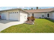 Exterior view of villa with garage and landscaping at 3712 3Rd W Ave, Palmetto, FL 34221