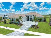Luxury home exterior with stone accents and palm trees at 11414 Brightly Dr, Venice, FL 34293
