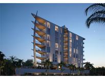 Modern building with water view at dusk at 688 Golden Gate Point # 501, Sarasota, FL 34236