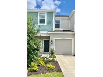 Two-story townhouse with teal and beige exterior at 3067 Novara Ln, Lakewood Ranch, FL 34211