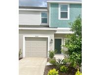Two-story townhome with attached garage and landscaped front yard at 3063 Novara Ln, Lakewood Ranch, FL 34211