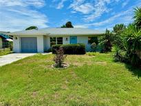 Newly remodeled home with a bright blue front door and attached garage at 3553 Syracuse St, Port Charlotte, FL 33952