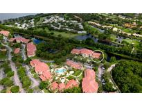 Beautiful aerial view of community with pool, green spaces, and waterway access at 4751 Travini Circle # 4-116, Sarasota, FL 34235