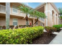Exterior view of building with landscaping at 811 Fairwaycove Ln # 107, Bradenton, FL 34212