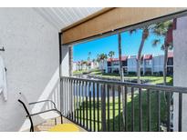 Balcony overlooking a tranquil canal with lush landscaping and residential buildings at 1801 Gulf N Dr # 275, Bradenton Beach, FL 34217