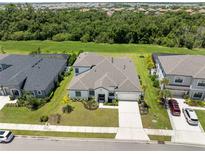 Aerial view of a single-Gathering home with a two-car garage and a large backyard at 4520 Pond Brook Ct, Bradenton, FL 34211