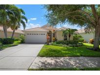 Single-story home with attached garage and manicured lawn at 4140 Reflections Pkwy, Sarasota, FL 34233